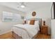 Cozy bedroom with a queen-sized bed, ceiling fan, hardwood floors and two bedside tables with lamps at 223 Grove St, Charleston, SC 29403