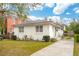 Charming single-story white brick home with a well-manicured lawn and a paved driveway at 223 Grove St, Charleston, SC 29403