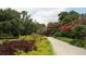 Scenic walking path lined with colorful gardens and mature trees provides a tranquil escape at 223 Grove St, Charleston, SC 29403