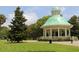 Elegant gazebo with a green roof surrounded by lush greenery and manicured lawns, perfect for relaxation at 223 Grove St, Charleston, SC 29403