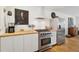 Kitchen featuring stainless steel oven, range, vent hood, and large refrigerator at 223 Grove St, Charleston, SC 29403