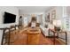 Open-concept living room with hardwood floors, modern furniture, and ample natural light at 223 Grove St, Charleston, SC 29403