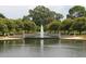 Picturesque water feature with a central fountain, bordered by manicured trees and walking paths at 223 Grove St, Charleston, SC 29403