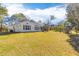 Expansive backyard featuring a well-maintained lawn, mature trees, and a play structure at 233 Ashmont Dr, Wando, SC 29492