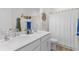 Well-lit bathroom featuring a double vanity with quartz countertops and nautical decor at 233 Ashmont Dr, Wando, SC 29492