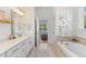Relaxing main bathroom with a soaking tub, double vanity, and neutral tones at 233 Ashmont Dr, Wando, SC 29492