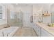 Bright bathroom featuring a soaking tub, glass shower, and double vanity at 233 Ashmont Dr, Wando, SC 29492