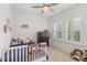 Bright, playful bedroom with natural light features a basketball hoop and ceiling fan at 233 Ashmont Dr, Wando, SC 29492