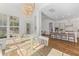 Sunlit dining area showcases a wooden table and chairs with views to the outdoors and open to the kitchen at 233 Ashmont Dr, Wando, SC 29492