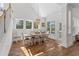 Bright dining area features large windows, hardwood floors, and a decorative chandelier at 233 Ashmont Dr, Wando, SC 29492