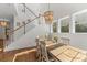 Dining area with staircase, hardwood floors, large windows and decorative lighting at 233 Ashmont Dr, Wando, SC 29492