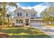 Charming two-story home with a well-manicured lawn and a spacious two-car garage at 233 Ashmont Dr, Wando, SC 29492