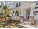 Charming front porch with brick accents and hanging plants, enhancing curb appeal at 233 Ashmont Dr, Wando, SC 29492
