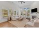 Spacious living room with a fireplace, large windows, and a comfortable seating arrangement at 233 Ashmont Dr, Wando, SC 29492