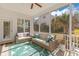 Inviting screened porch with stylish seating and lush green foliage at 233 Ashmont Dr, Wando, SC 29492