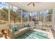 Relaxing screened porch furnished with comfortable seating and a view of the backyard at 233 Ashmont Dr, Wando, SC 29492