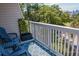 Inviting balcony with blue rug, patio furniture, and serene views of lush greenery at 259 Sea Cloud Cir, Edisto Island, SC 29438