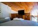Cozy bedroom with two beds, a TV, wood paneling and sloped wood ceiling at 259 Sea Cloud Cir, Edisto Island, SC 29438