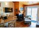 Comfortable living area with a fireplace, wood walls, and sliding glass doors to the outside at 259 Sea Cloud Cir, Edisto Island, SC 29438