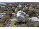 Aerial view showcases the home in a leafy neighborhood, highlighting the metal roof and manicured yard at 2607 Cameron Blvd, Isle of Palms, SC 29451