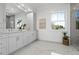 Stylish bathroom features a double vanity, elegant mirror, and bright natural light from the window at 2607 Cameron Blvd, Isle of Palms, SC 29451