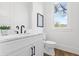 Modern powder room featuring a marble countertop, stylish fixtures, and natural light from the window at 2607 Cameron Blvd, Isle of Palms, SC 29451