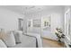 Bright bedroom showcasing a view of the home's exterior with light hardwood floors and white walls at 2607 Cameron Blvd, Isle of Palms, SC 29451