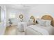 Bright bedroom features two twin beds, wood floors, and white walls to create a serene atmosphere at 2607 Cameron Blvd, Isle of Palms, SC 29451