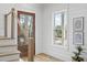 Bright entryway featuring wood floors, white walls, and a modern staircase with cable railings at 2607 Cameron Blvd, Isle of Palms, SC 29451