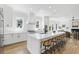 Bright white kitchen with island and barstool seating overlooks the open-concept living area at 2607 Cameron Blvd, Isle of Palms, SC 29451