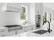 Close-up of white kitchen with stainless appliances, gas range, and tiled backsplash at 2607 Cameron Blvd, Isle of Palms, SC 29451