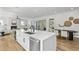 Open-concept kitchen with large island and stainless steel dishwasher flows into the living and dining areas at 2607 Cameron Blvd, Isle of Palms, SC 29451