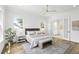 Sunlit main bedroom with hardwood floors, two large windows, and a partial view of the ensuite bathroom at 2607 Cameron Blvd, Isle of Palms, SC 29451