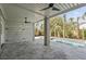 Covered outdoor patio featuring sleek ceiling fans offering a cool view of the pool and beautifully landscaped backyard at 2607 Cameron Blvd, Isle of Palms, SC 29451
