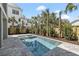 Inviting backyard pool and spa are surrounded by lush landscaping, including palm trees and privacy fencing at 2607 Cameron Blvd, Isle of Palms, SC 29451