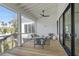 Relaxing outdoor covered porch with modern furniture and vaulted ceiling at 2607 Cameron Blvd, Isle of Palms, SC 29451