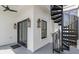 Inviting covered porch with black spiral staircase, ceiling fan and stylish lanterns at 2607 Cameron Blvd, Isle of Palms, SC 29451