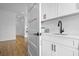 Bright wet bar with open hallway, sink, and open shelving at 2607 Cameron Blvd, Isle of Palms, SC 29451