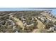 Aerial view of community with lush tree cover and golf course along the ocean at 263 Sea Cloud Cir, Edisto Island, SC 29438