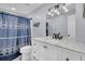 Stylish bathroom featuring a modern vanity, framed mirror, and shower with blue curtain at 263 Sea Cloud Cir, Edisto Island, SC 29438