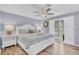 Serene bedroom with a queen-sized bed, ceiling fan, and access to a private balcony at 263 Sea Cloud Cir, Edisto Island, SC 29438