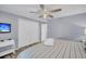 Bright bedroom with a queen-sized bed, a TV, a ceiling fan, and a closet at 263 Sea Cloud Cir, Edisto Island, SC 29438