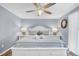 Inviting bedroom featuring a queen-sized bed, ceiling fan, and soothing coastal decor at 263 Sea Cloud Cir, Edisto Island, SC 29438