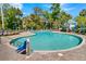 Refreshing community pool with lounge chairs, umbrellas, and a lift for accessibility, surrounded by lush greenery at 263 Sea Cloud Cir, Edisto Island, SC 29438