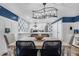 Stylish dining area with modern chandelier, trendy chairs, and an open layout to the kitchen at 263 Sea Cloud Cir, Edisto Island, SC 29438