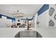 Modern kitchen island features a stainless steel sink, ample counter space, and breakfast bar seating at 263 Sea Cloud Cir, Edisto Island, SC 29438