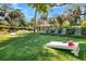 Enjoy outdoor games and relaxation on the lush lawn with lounge chairs and a cornhole setup for entertainment at 263 Sea Cloud Cir, Edisto Island, SC 29438