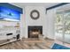 Comfortable living room with a fireplace, TV, and sliding glass door that allows a great view of outside at 263 Sea Cloud Cir, Edisto Island, SC 29438