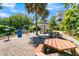 Outdoor picnic area with charcoal grill, trash can, and several wooden picnic tables at 263 Sea Cloud Cir, Edisto Island, SC 29438