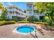 Community offers a small outdoor hot tub surrounded by brick pavers, palm trees, and well maintained two-story condos at 263 Sea Cloud Cir, Edisto Island, SC 29438